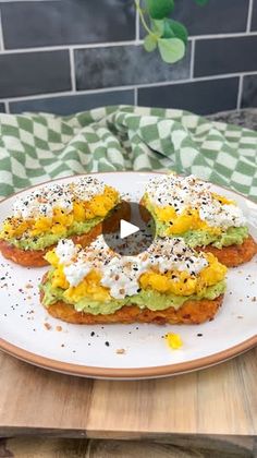 an avocado sandwich is sitting on a white plate with sprinkles