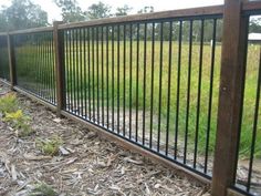 a fence that is next to some grass