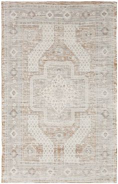 an area rug with brown and white designs on the front, in shades of beige