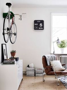 a living room with a bicycle mounted to the wall