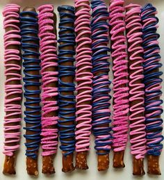 several donuts with pink, blue and brown icing