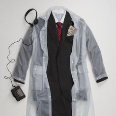 a man's suit and tie are laid out on the floor next to headphones