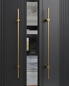 two black double doors with gold handles on each side and an open door in the middle