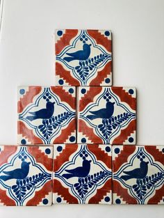 four red and blue tiles with birds on them