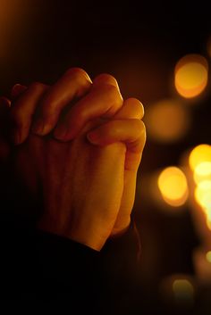 a person holding their hands together in prayer