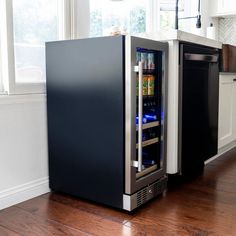 a refrigerator with its door open in a kitchen