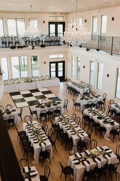 a large room with tables and chairs set up for a formal function in the center