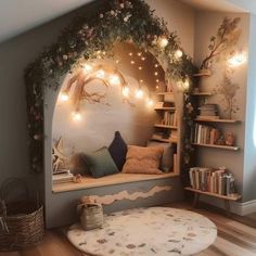 a room with some lights on the wall and bookshelves in front of it