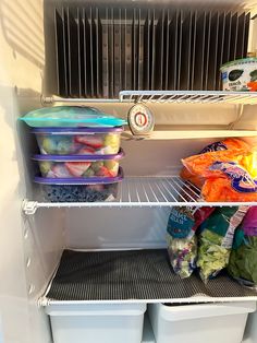 an open refrigerator filled with lots of food and plastic containers on the shelf next to it