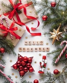 the word hello december spelled with scrabbles, candy canes and christmas decorations