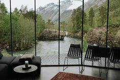 a living room filled with furniture next to a river