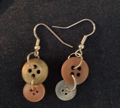 two pairs of earrings with buttons attached to them