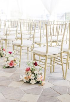 rows of chairs lined up with flowers on them