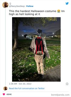 a man wearing a hat and suspenders is standing in the grass with his back to the camera