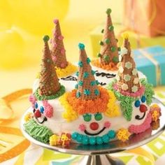 a birthday cake decorated with clown hats and decorations