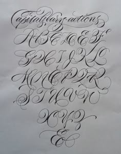 an old fashioned script that has been written in cursive writing with black ink