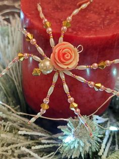 a candle with beads and a rose on it