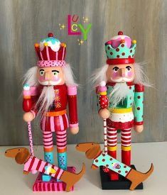 two wooden nutcrackers are standing next to each other