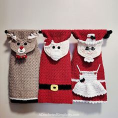 crocheted christmas towels hanging on the wall with santa's helpers attached to them