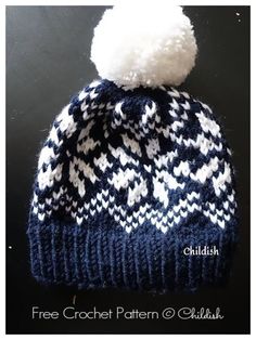 a blue and white knitted hat with a pom - pom