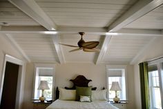 a bedroom with a bed and ceiling fan