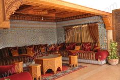 a living room filled with lots of couches and tables next to each other on top of a hard wood floor