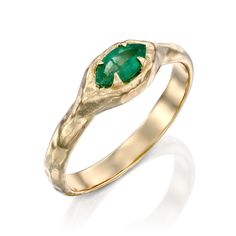 Mystic Eden Marquise Ring- Emerald Embrace the timeless charm of the Mystic Eden Marquise Ring. Its vibrant emerald hue emits a delicate, captivating radiance. This stunning ring is certain to capture attention. Materials Description:- 14K gold- 0.35ct marquise shape Emerald.- Rough texture, High polish. - We are using only natural stones. Each stone is unique. Emerald: The stone of a mighty heart.With its remarkable, eye-catching deep color, Emerald became known as the stone attracting mighty h Heirloom Style Emerald Ring With Halo, Heirloom Emerald Ring With Halo, Marquise Emerald Ring In Yellow Gold, Green Bezel Set Signet Ring For Wedding, Green Signet Ring With Bezel Setting For Wedding, Emerald Marquise Promise Ring For May Birthstone, Marquise Emerald Ring For Promise In May, Heirloom Marquise Emerald Ring, Heirloom Emerald Marquise Rings