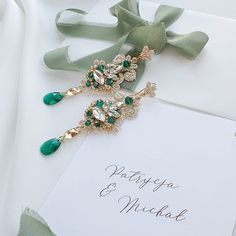 Elevate your bridal elegance with our stunning Lace Bride Earrings. Meticulously crafted for the discerning bride, these exquisite earrings combine the timeless beauty of lace design with the brilliance of encrusted crystals. Each earring features a delicate lace pattern adorned with shimmering crystals that catch the light from every angle, creating a dazzling effect. The centerpiece of these earrings is a captivating emerald teardrop crystal, adding a touch of sophistication and a pop of vibrant color. The emerald crystal is flawlessly cut to enhance its natural sparkle, making it the perfect accent to your bridal ensemble. Whether you're walking down the aisle or dancing the night away, these earrings will ensure you shine with unparalleled grace and style. Perfect for weddings, anniver Wedding Earrings Chandelier, Long Bridal Earrings, Pearl Bride, Statement Earrings Wedding, Crystals Earrings, Wedding Chandelier, Lace Bride, Bridal Elegance, Bride Earrings