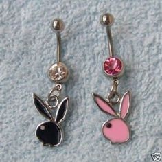 two dangling belly rings with pink and black bunny ears on each one, the other side