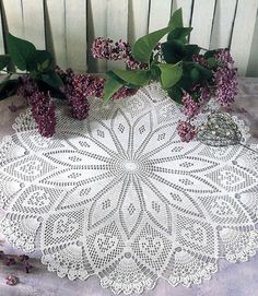 a white doily with purple flowers on it