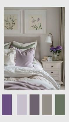 a white bed with purple and green pillows on top of it, in front of two framed pictures