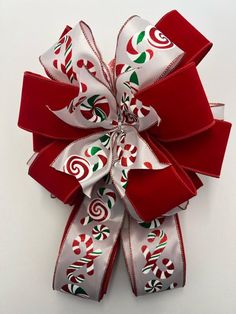 a red and white bow with candy canes on it