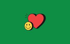 a heart and a smiley face on a green background