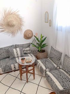 a living room with black and white patterned furniture