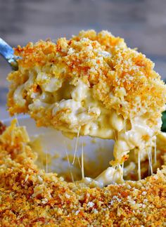 the best homemade macaroni and cheese is being lifted with a fork from a casserole dish