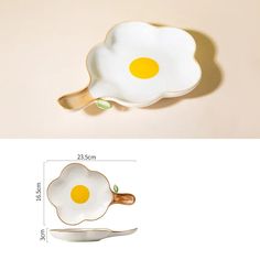 an egg shaped dish with two eggs in the middle and a fork next to it