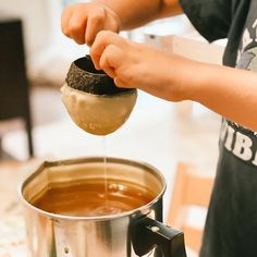 a person is pouring something into a pot