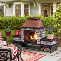 an outdoor fireplace in the middle of a patio