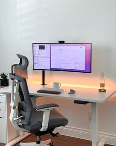 a computer desk with a monitor and keyboard on it