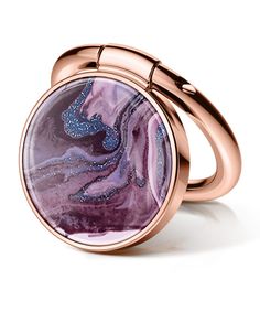 a pink ring with purple and blue swirls on the outside, set in 18k rose gold