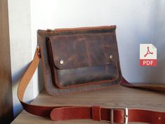 a brown leather purse sitting on top of a wooden table next to a white wall