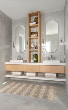 a bathroom with two sinks and mirrors in it