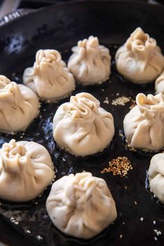 some dumplings are being cooked in a skillet