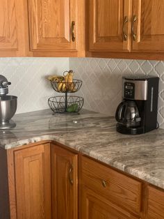 a kitchen counter with some bananas on top of it and a coffee maker in the corner