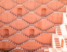 an intricately designed wall made out of blocks and bricks with steps leading up to the top