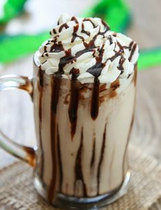 a glass cup filled with hot chocolate and whipped cream