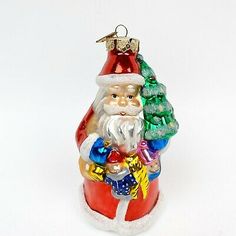 a glass santa clause ornament with christmas decorations