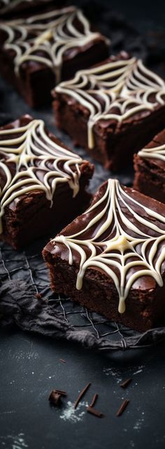 chocolate brownies with white icing on a cooling rack