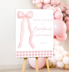 a welcome sign for a baby shower with balloons in the background