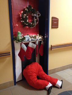 a man dressed as santa clause laying on the floor